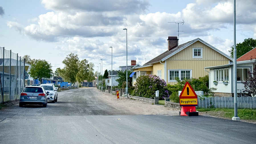 Västra vägen längs med Strandskolan i Karlsborg med bilar parkerade på sidan av den.