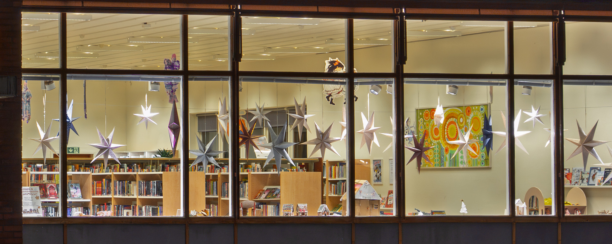 Bibliotek med julstjärnor i fönstret
