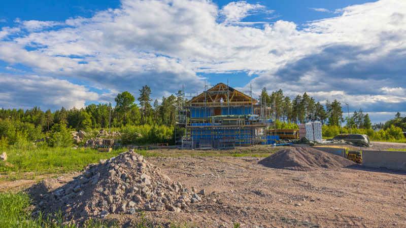 En stor hög med jord framför en byggnad under uppförande.