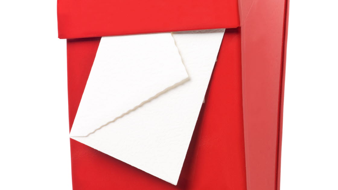 Röd brevlåda med ett kuvert hängande i öppningen